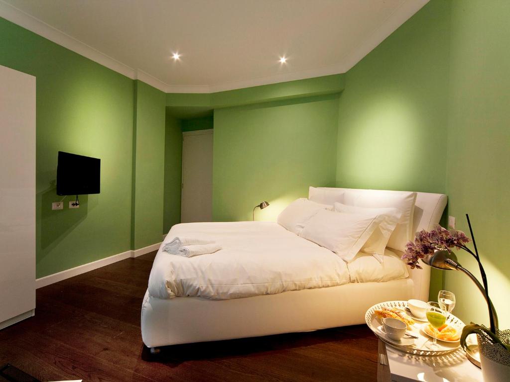 A bed or beds in a room at The One Prati Rooms