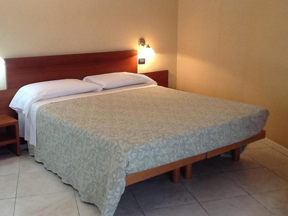 Postel nebo postele na pokoji v ubytování CerrutiHotel