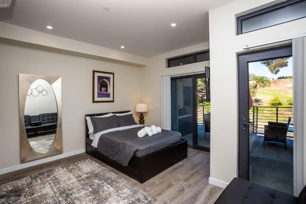 a bedroom with a bed and a large mirror at Awesome Balboa Park View with Huge Balcony in SD in San Diego