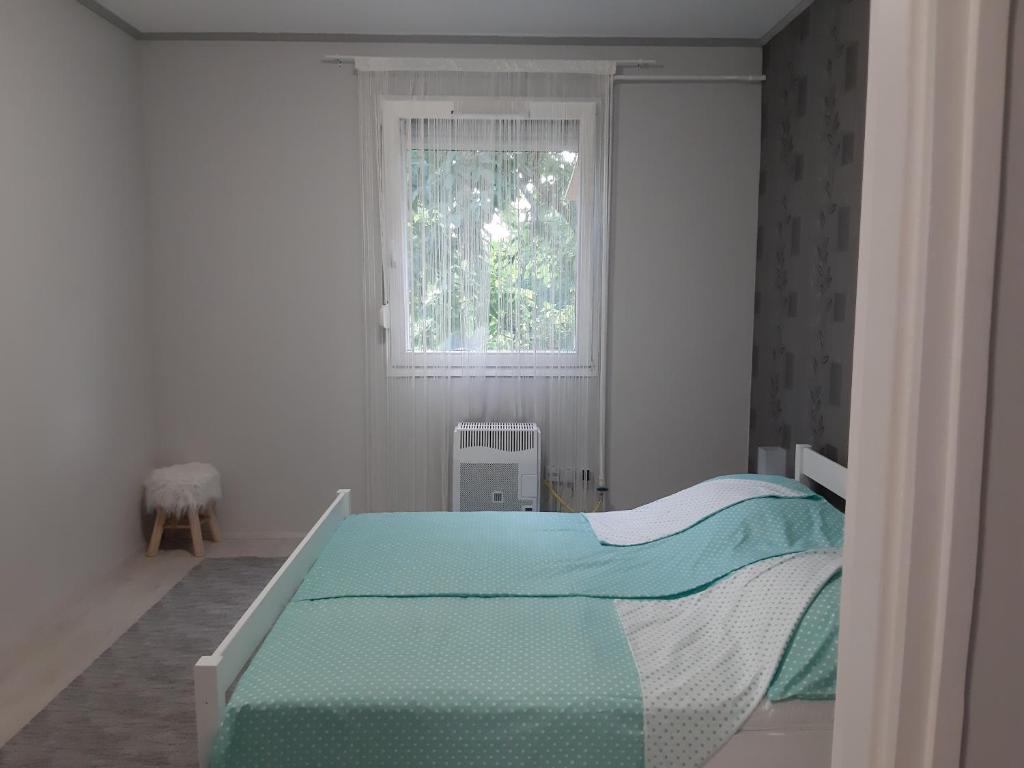 A bed or beds in a room at Jade Vendégház