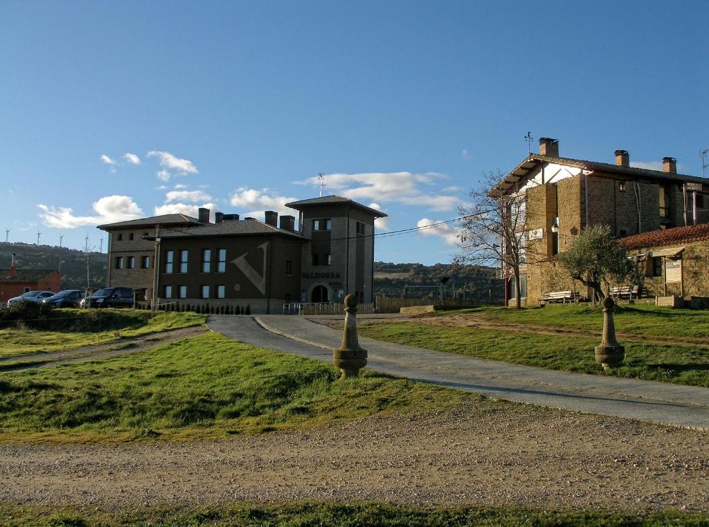 una carretera que conduce a un edificio en una colina en Hotel Rural Valdorba, en Sansoáin