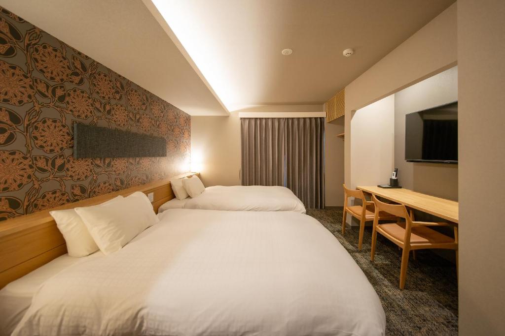 Postel nebo postele na pokoji v ubytování Hotel Celeste Shizuoka