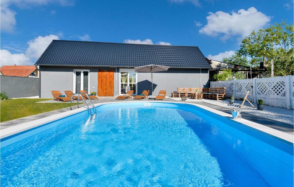a swimming pool in front of a house at Awesome Home In Svibovec Podravski With Kitchen in Svibovec Podravski