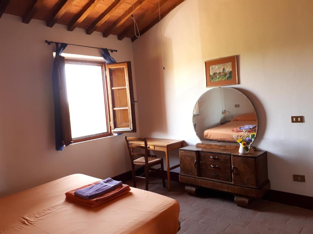 Postel nebo postele na pokoji v ubytování Podere Calcinaia