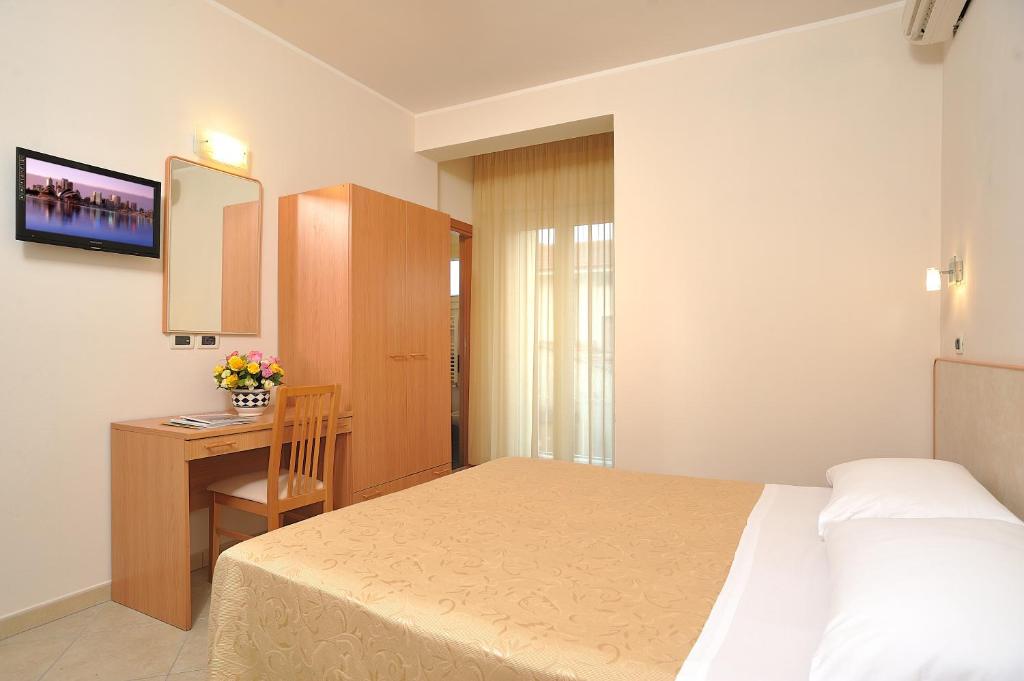 Postel nebo postele na pokoji v ubytování Hotel Favorita