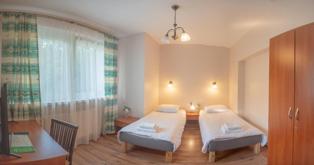 Posteľ alebo postele v izbe v ubytovaní Dom Wczasowy Beskidy