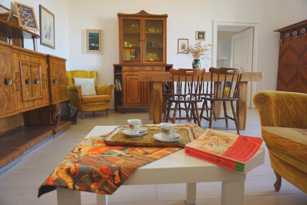 a living room with a coffee table with a book at Nomadi Sedentari - Irsina in Irsina