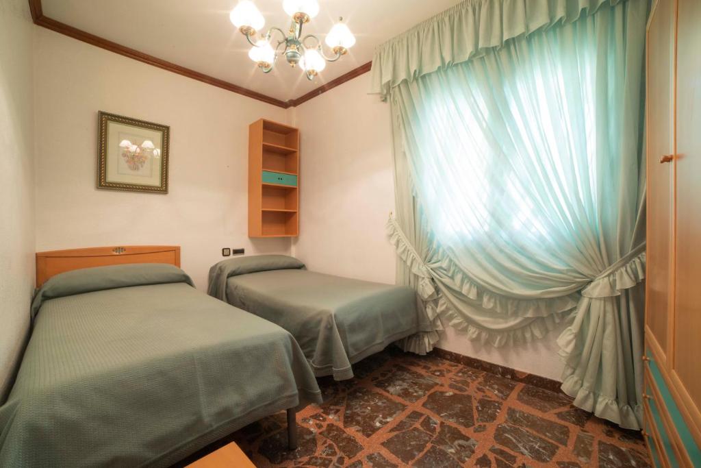 A bed or beds in a room at TurJalon - Apartamentos