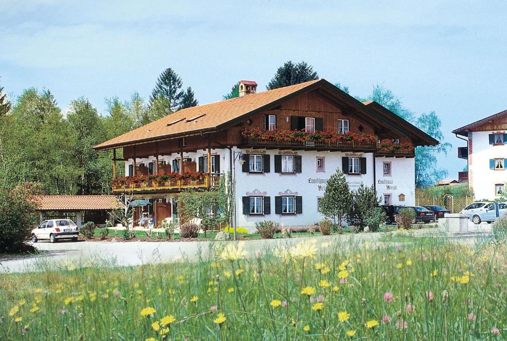 um grande edifício com flores em frente em Landhaus Brigitte em Bayersoien