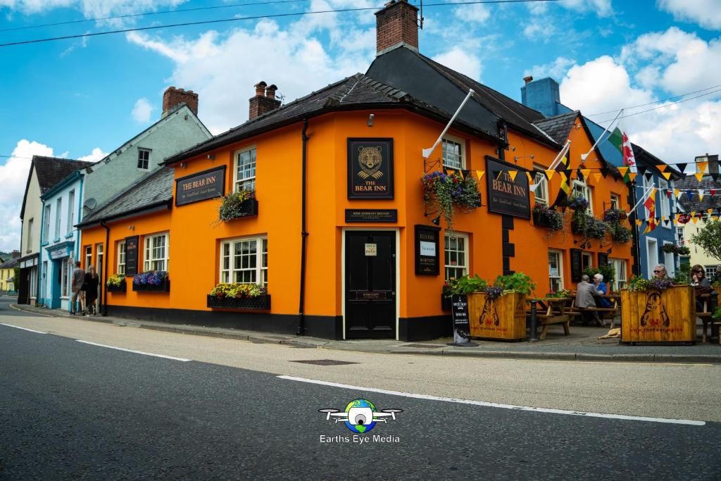 an orange building on the side of a street at The Bear Inn in Llandovery