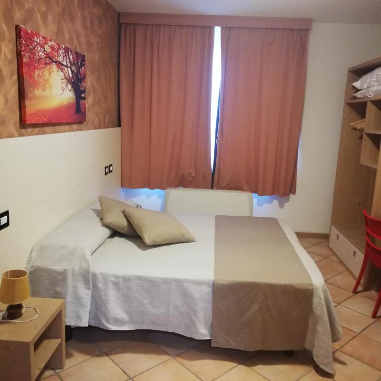 Postel nebo postele na pokoji v ubytování Agriturismo Pituello