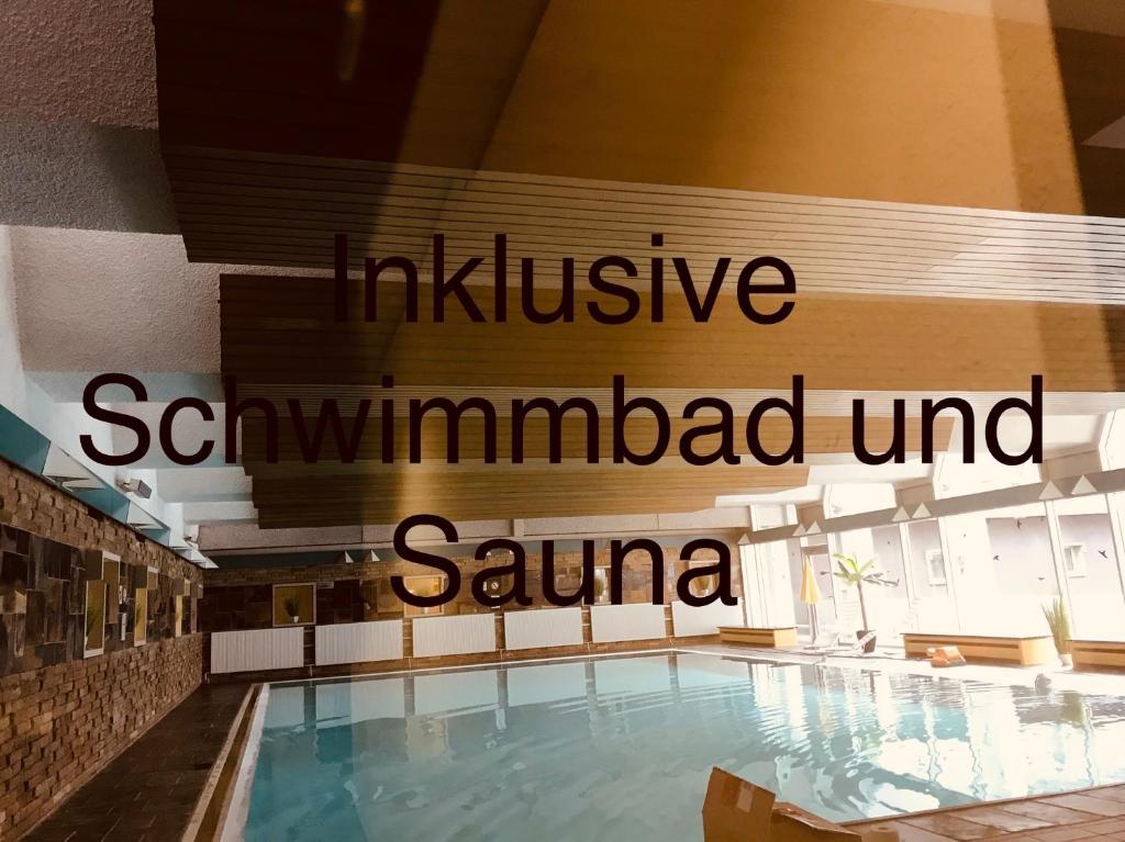 a swimming pool with a sign that reads inclusive seawamped senna at Waldblick - Bad Harzburg inklusive Schwimmbad und Sauna in Bad Harzburg