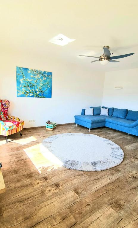 a living room with a blue couch and a rug at Sanosueno 4 in Sonthofen