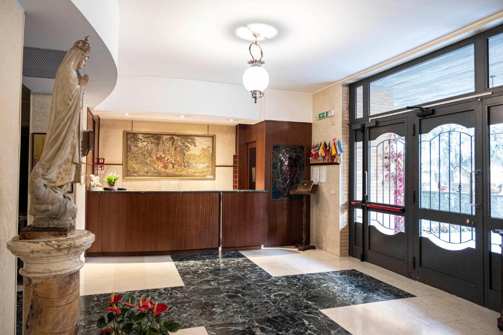 a lobby with a statue in the middle of a building at Villa Fatima, Casa per Ferie in Rome
