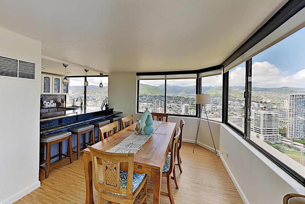 a dining room with a table and some windows at Hawaiian Monarch 203 condo in Honolulu