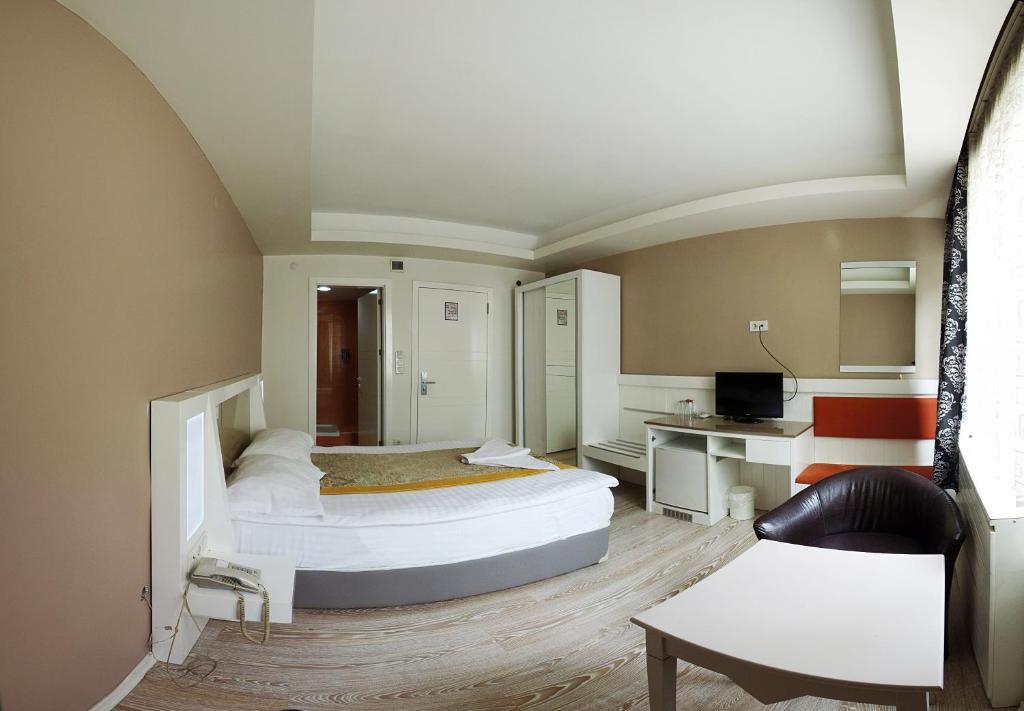 a hotel room with two beds and a desk at Grand As Hotel in Istanbul