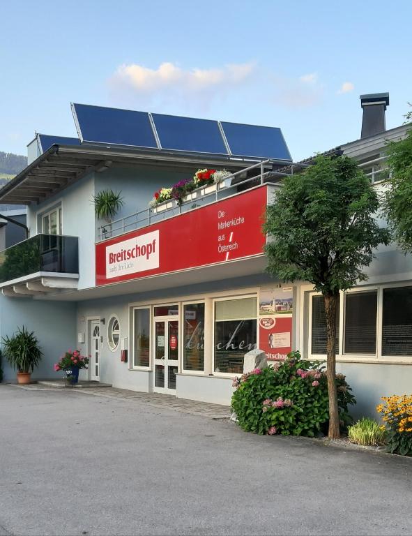 a building with a red sign on the side of it at Ferienwohnung Mühlburger in Lienz