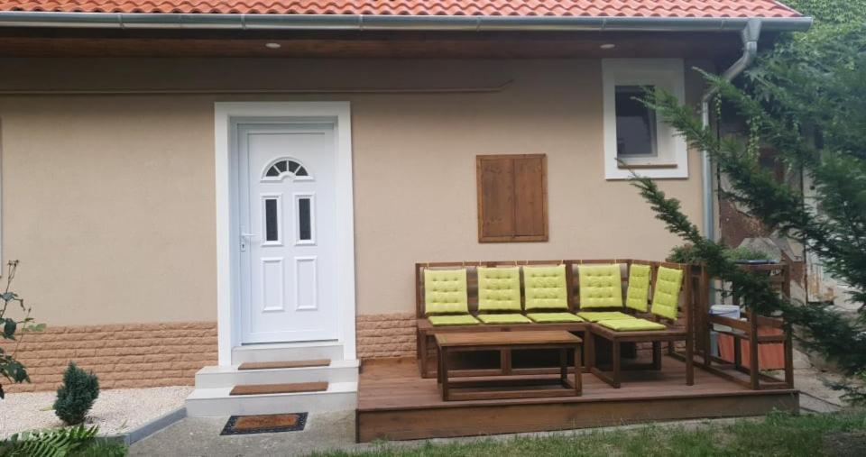 a porch with two benches on a house at VILLA NEAPOLiS in Pécs