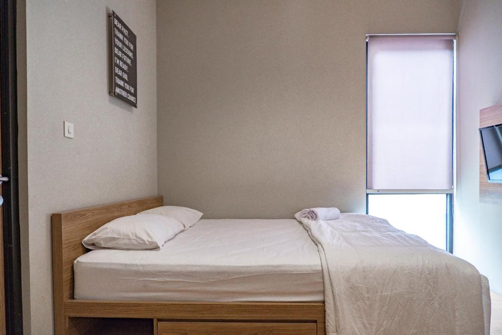 Postel nebo postele na pokoji v ubytování Three J Residence 2