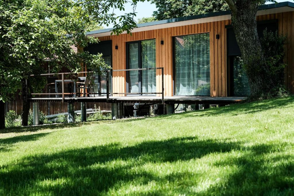 a house with a deck and a grass yard at Ferienhaus erholzeit. in Wettringen