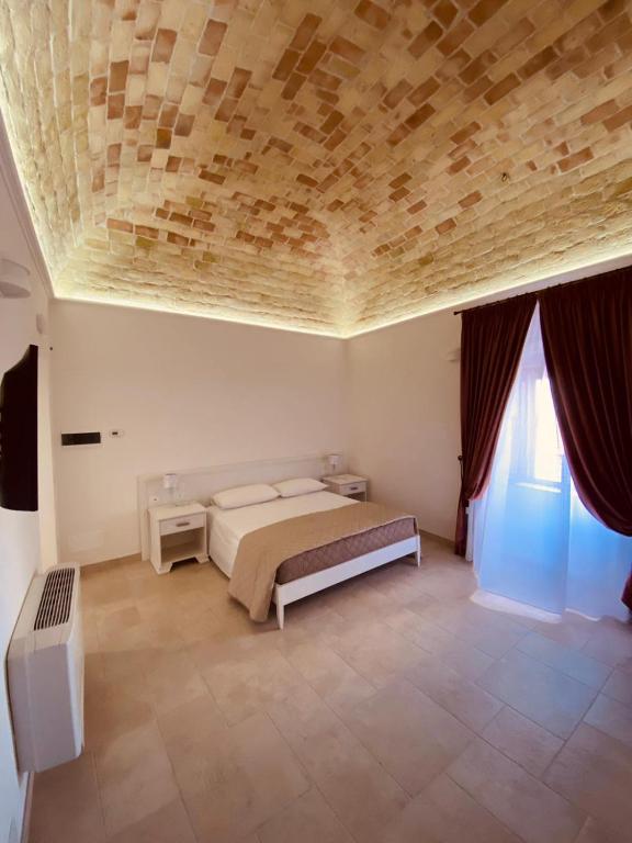 A bed or beds in a room at RELAIS SAN MARCO LUXURY GUEST HOUSE