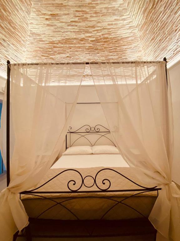 A bed or beds in a room at RELAIS SAN MARCO LUXURY GUEST HOUSE