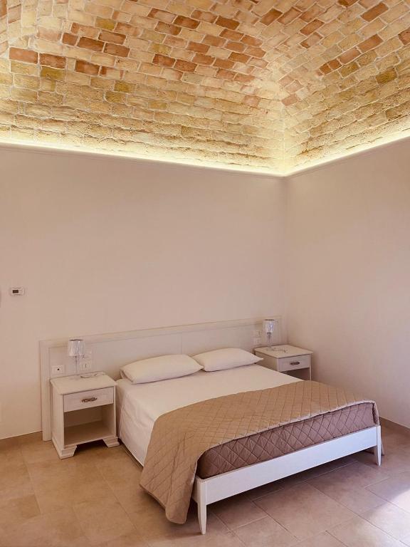 A bed or beds in a room at RELAIS SAN MARCO LUXURY GUEST HOUSE