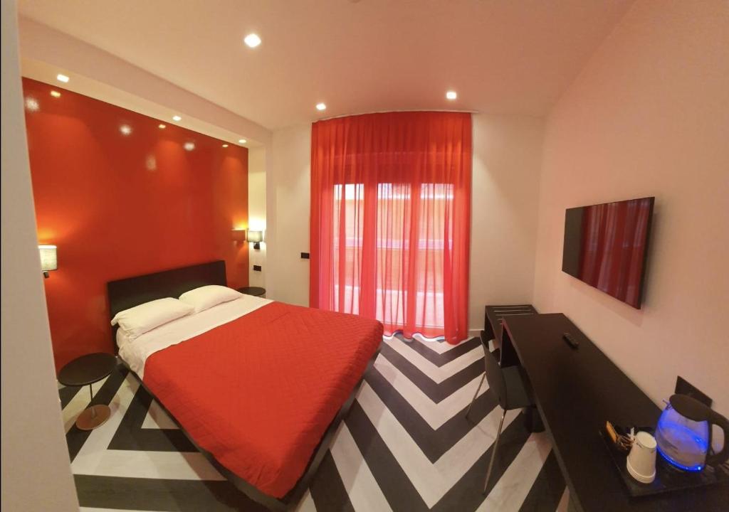 a bedroom with a red bed and a checkered floor at The White Lodge in Sorrento