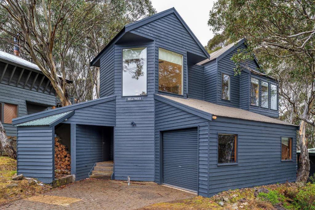 a blue house with a gambrel roof at Belltrees in Dinner Plain