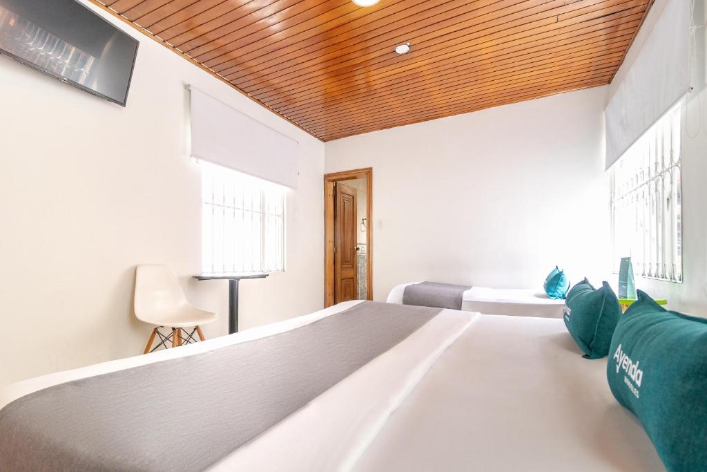 Postel nebo postele na pokoji v ubytování Hotel Quintas de Normandia