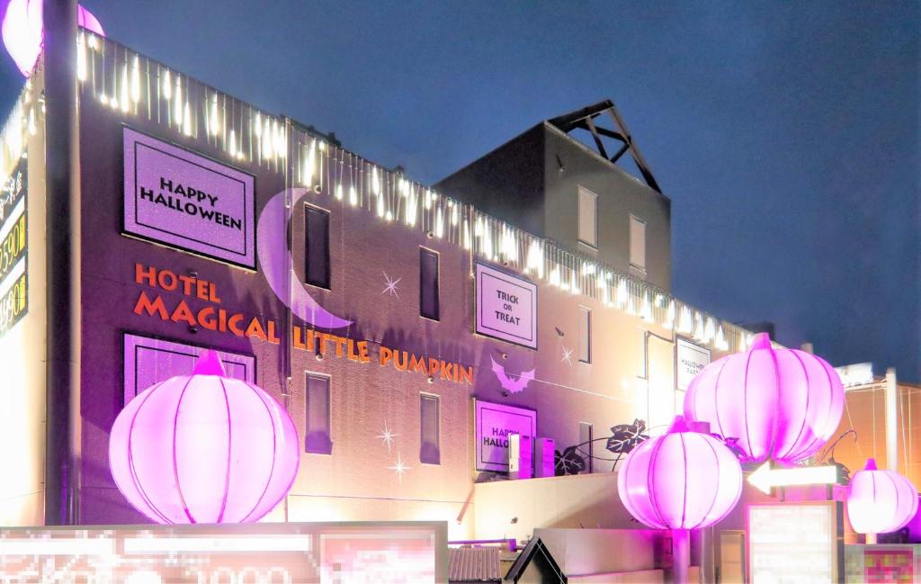 a hotel with pink lanterns in front of a building at Magical Pumpkin Sweet Garden leisure hotel in Okayama