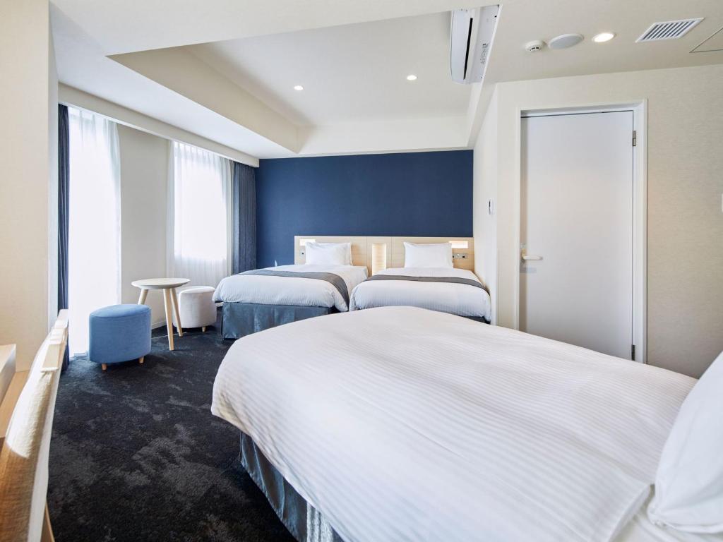 Postel nebo postele na pokoji v ubytování Hotel Keyaki Gate Tokyo Fuchu