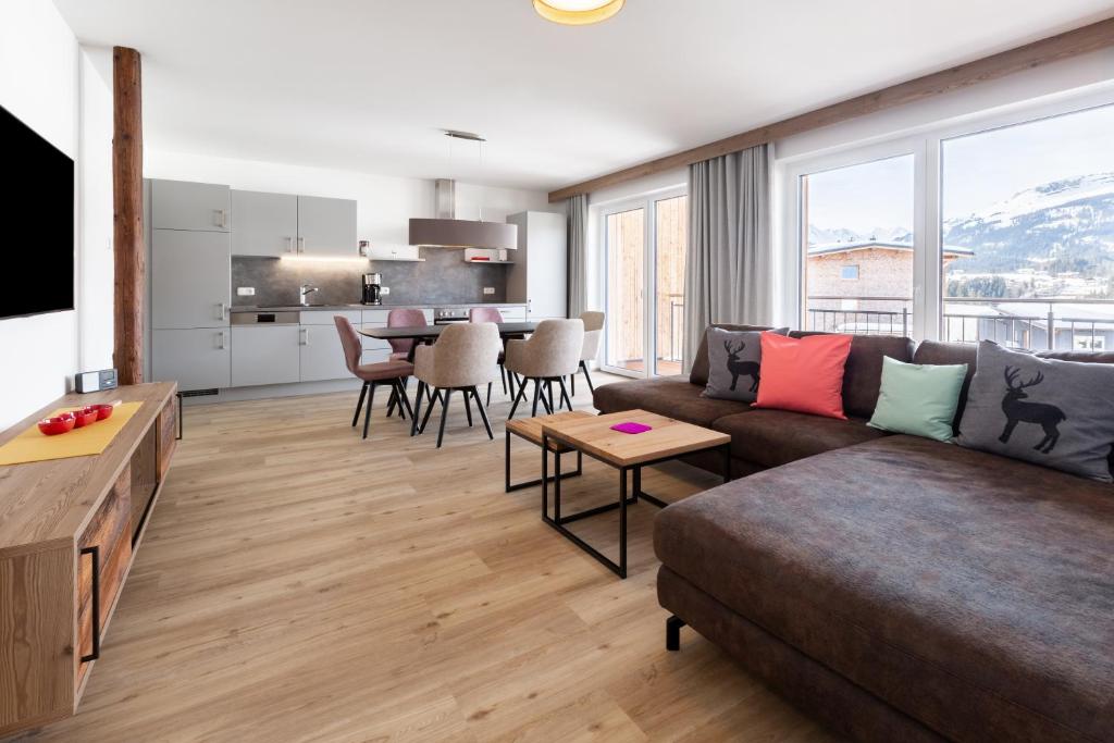 a living room with a couch and a table at Haus Fellhorn - Ferienwohnungen in Riezlern