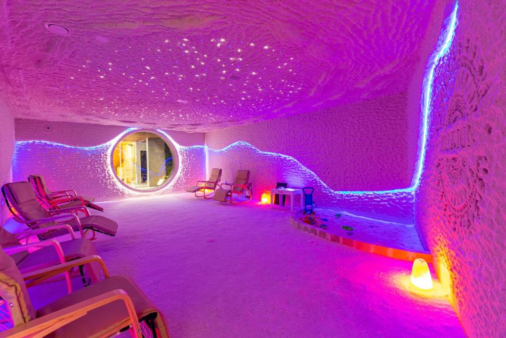 a room with purple lights and chairs in it at MARION SPA Hotel & Spa - RENOVATION - Rooms, SPA area, Swimming pool, Reception, Restaurant, Lounge Bar, Hookah bar, Children's room, Parking, SPA and Breakfast included in the price in Bukovel