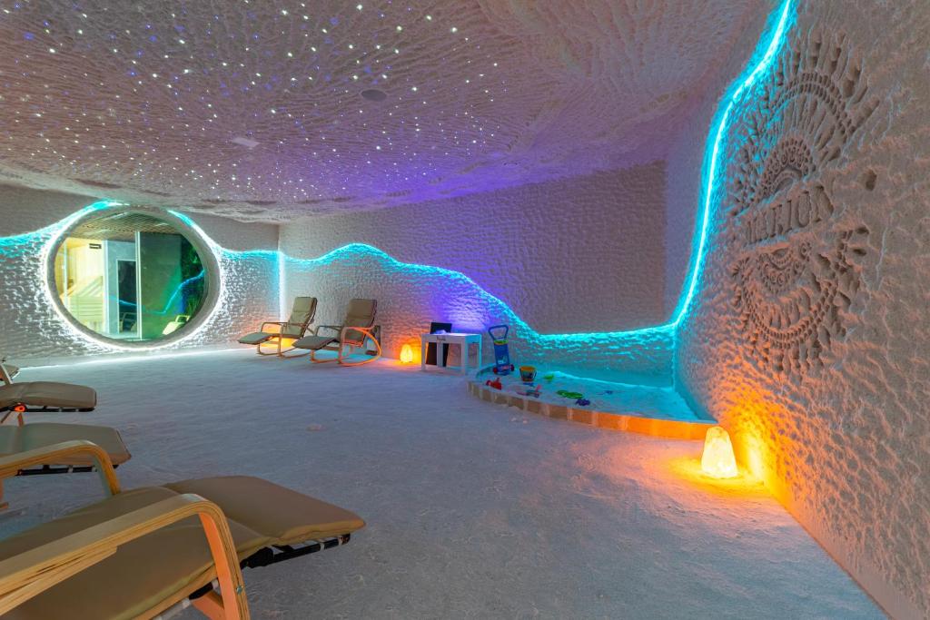 a room with blue and purple lights on the wall at MARION SPA Hotel & Spa - RENOVATION - Rooms, SPA area, Swimming pool, Reception, Restaurant, Lounge Bar, Hookah bar, Children's room, Parking, SPA and Breakfast included in the price in Bukovel