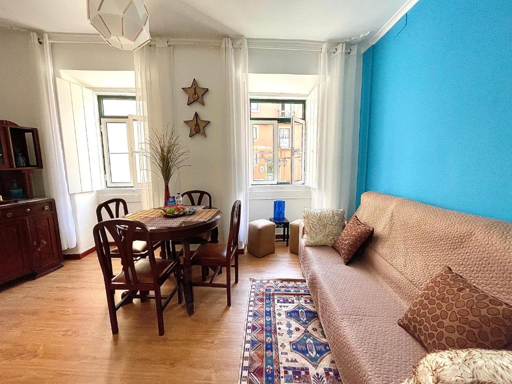 a living room with a table and a couch at The Spot in Alfama in Lisbon