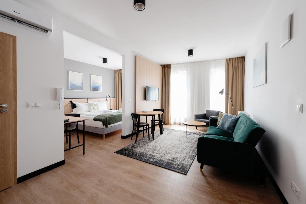 a living room with a couch and a table at Apartamenty Zamoyskiego Warszawa Stadion in Warsaw