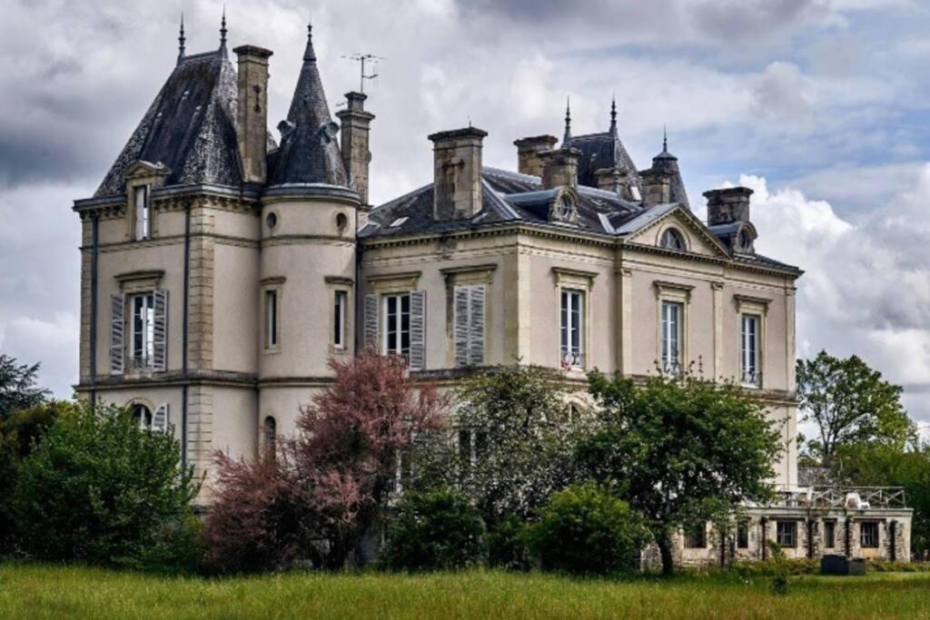 an old castle with turrets on top of a field at 24 heures du Mans. Château aux portes du circuit in Moncé-en-Belin