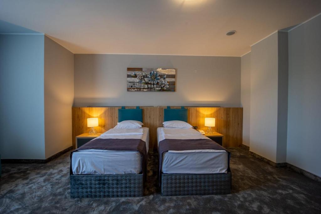 Postel nebo postele na pokoji v ubytování Hotel Caesar 2