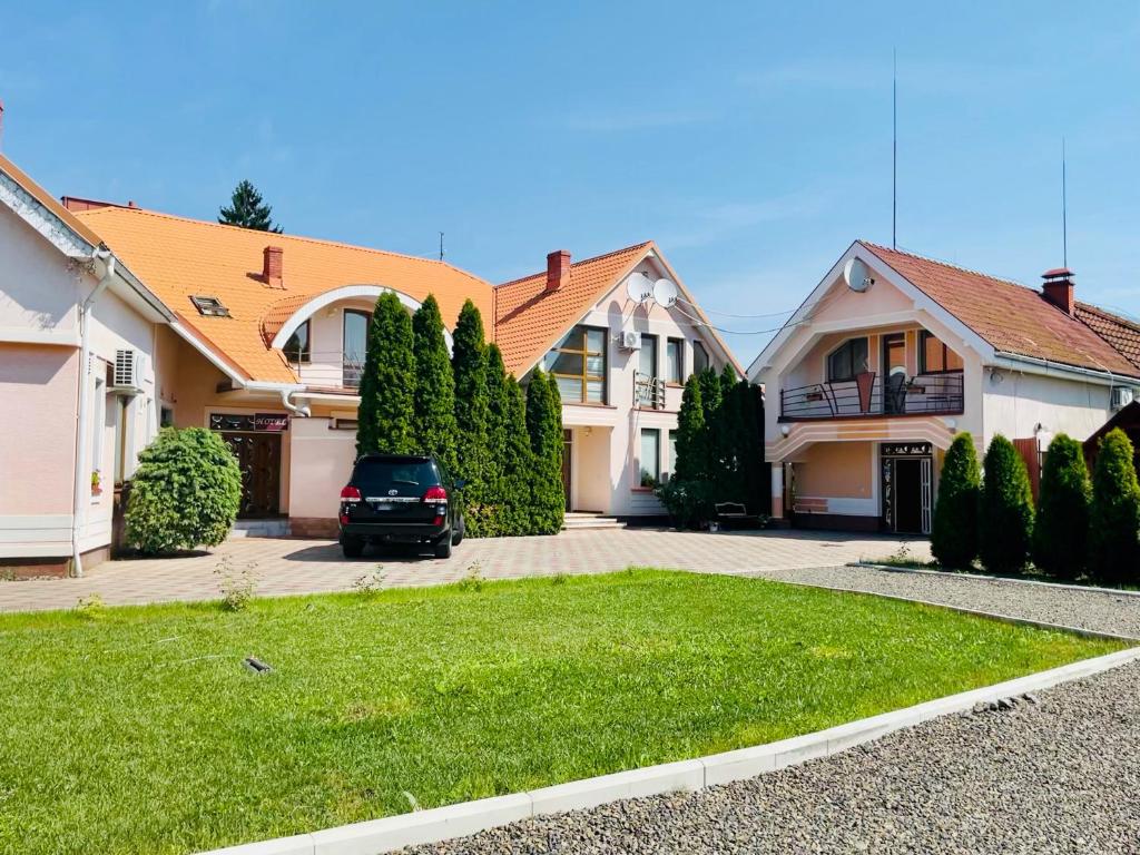 a house with a car parked in the driveway at U Anity in Uzhhorod