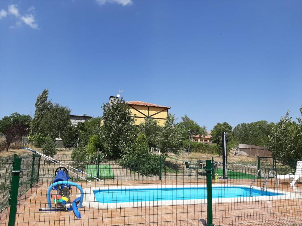 a playground with two pools and a slide at Hospederia La Serrota in Narros del Puerto