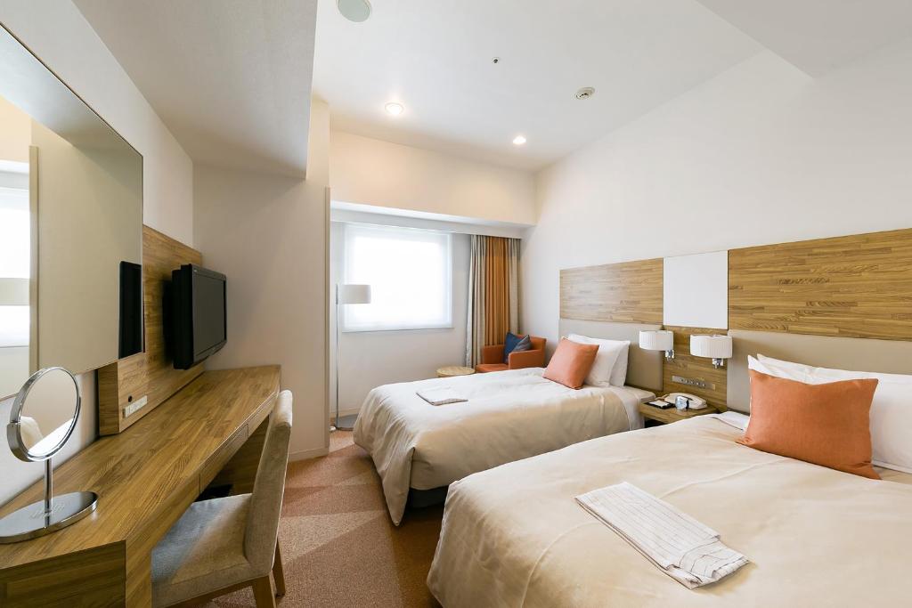 Postel nebo postele na pokoji v ubytování Sotetsu Fresa Inn Nagano-Zenkojiguchi
