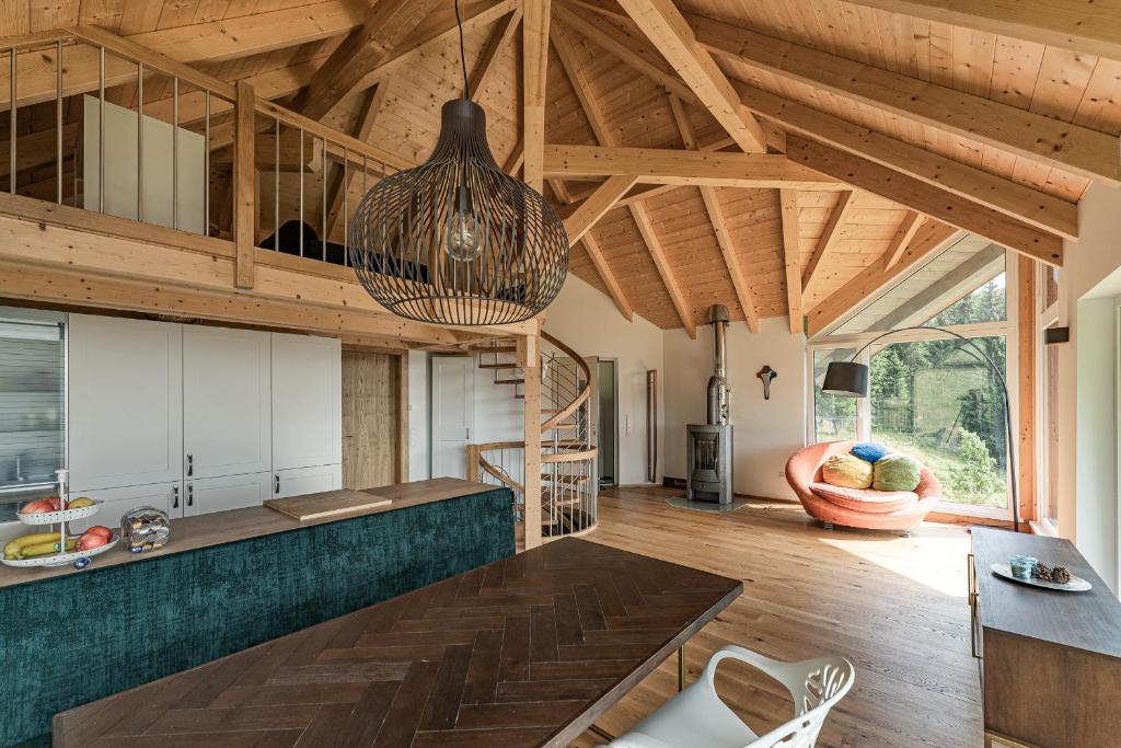 a kitchen with wooden ceilings and a dining room at Forsthaus Gray 4 in Sankt Veit an der Glan