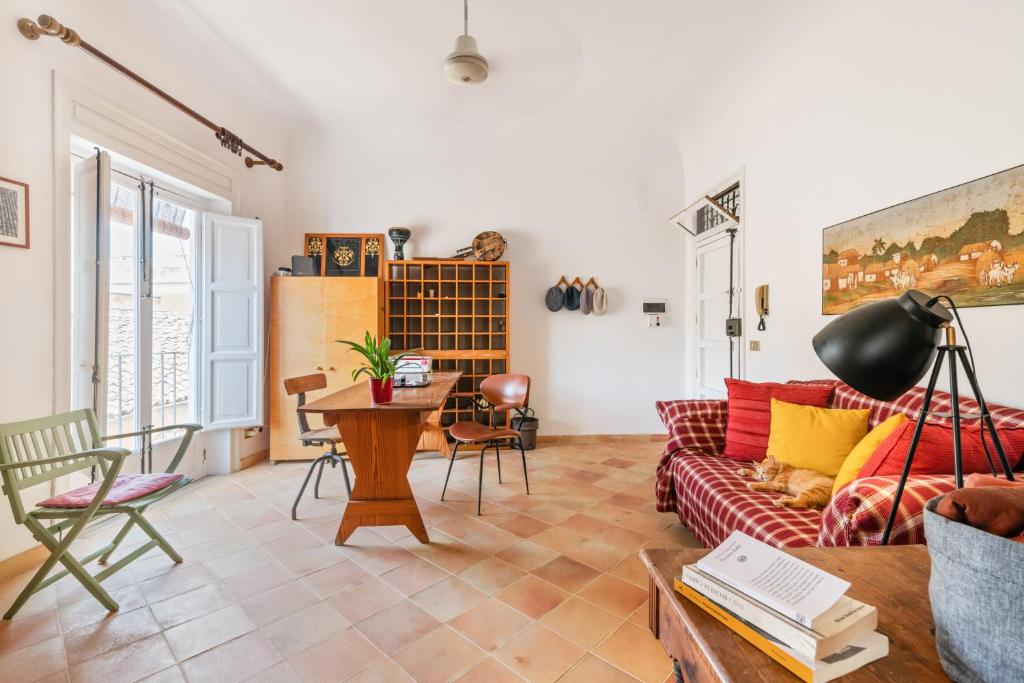 a living room with a couch and a table at "On the roofs of Trapani" Roomy Flat in Trapani