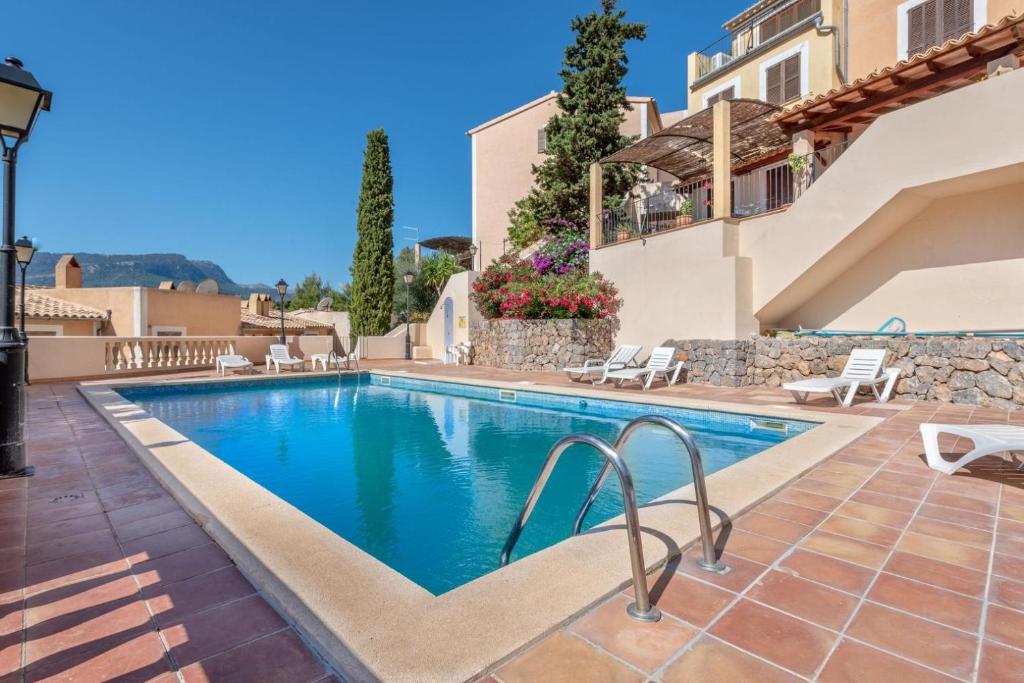 a swimming pool in the middle of a villa at Villa Carla in Port de Soller