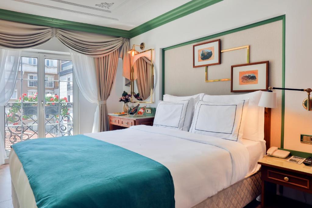 a bedroom with a large bed and a balcony at Orient Express & Spa by Orka Hotels in Istanbul