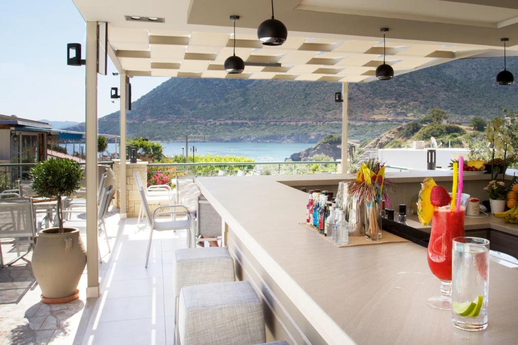 an outdoor bar with a view of the ocean at Amalia Apartments in Balíon