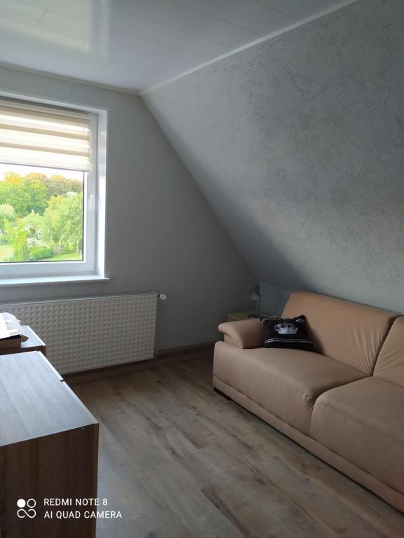 a living room with a couch and a window at Nina in Bad Wildungen