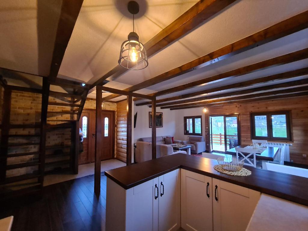 a kitchen with a counter top and a dining room at The Lake Breeze Bay in Plav
