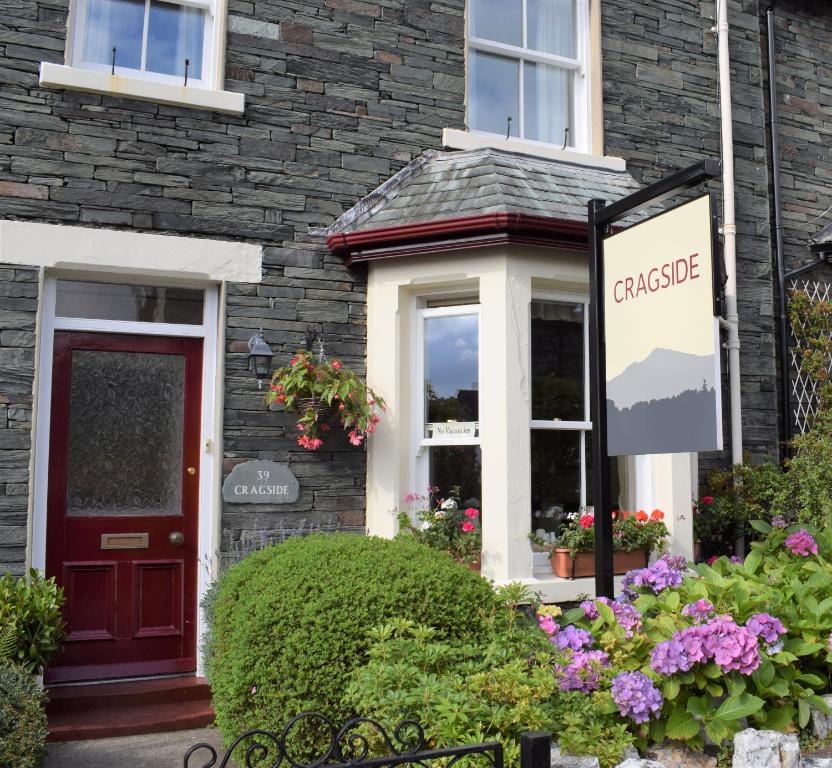 a house with a sign that reads cottage at Cragside B&B in Keswick